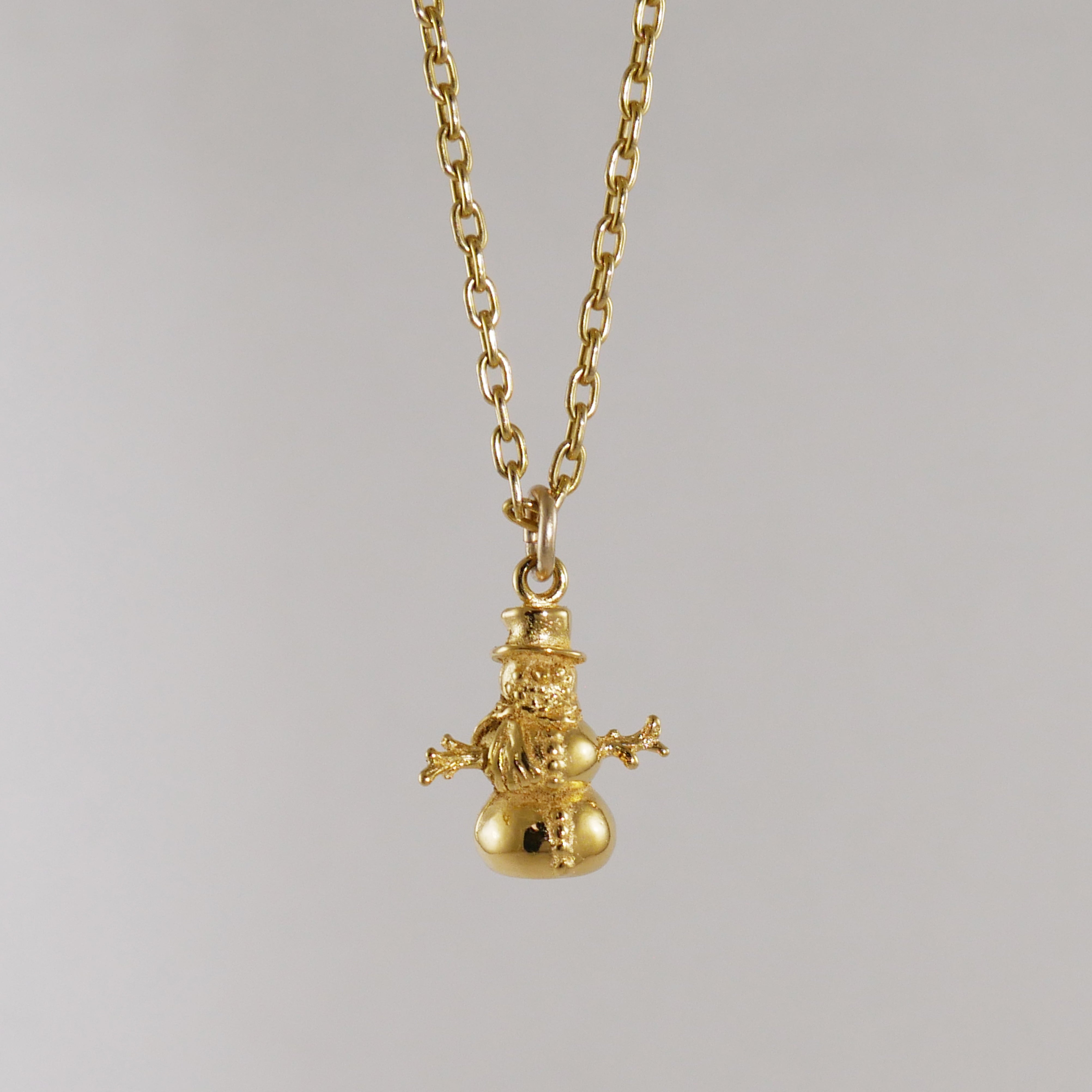 Gold snowman pendant on a chain