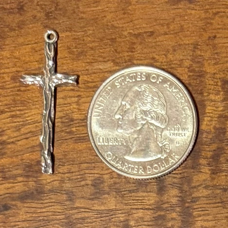 Silver cross pendant next to a U.S. quarter dollar - CharmWorks