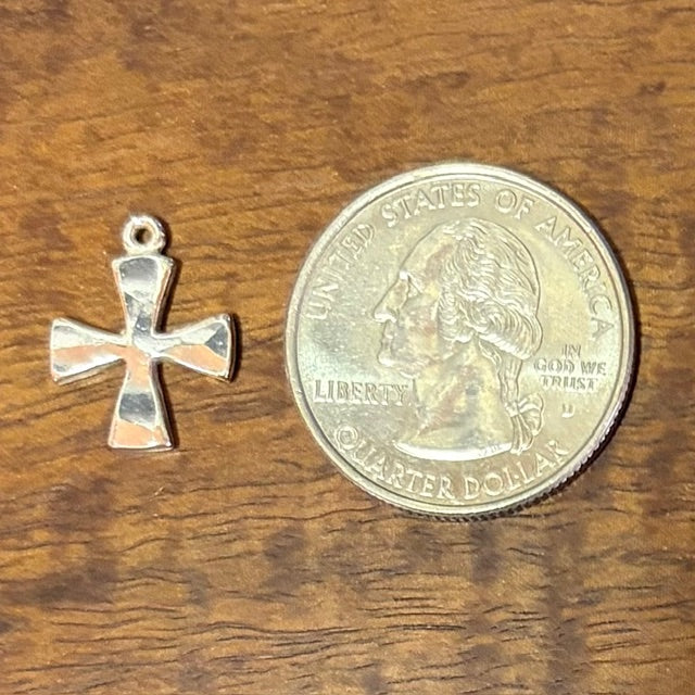 Silver cross pendant next to a U.S. quarter dollar coin - CharmWorks