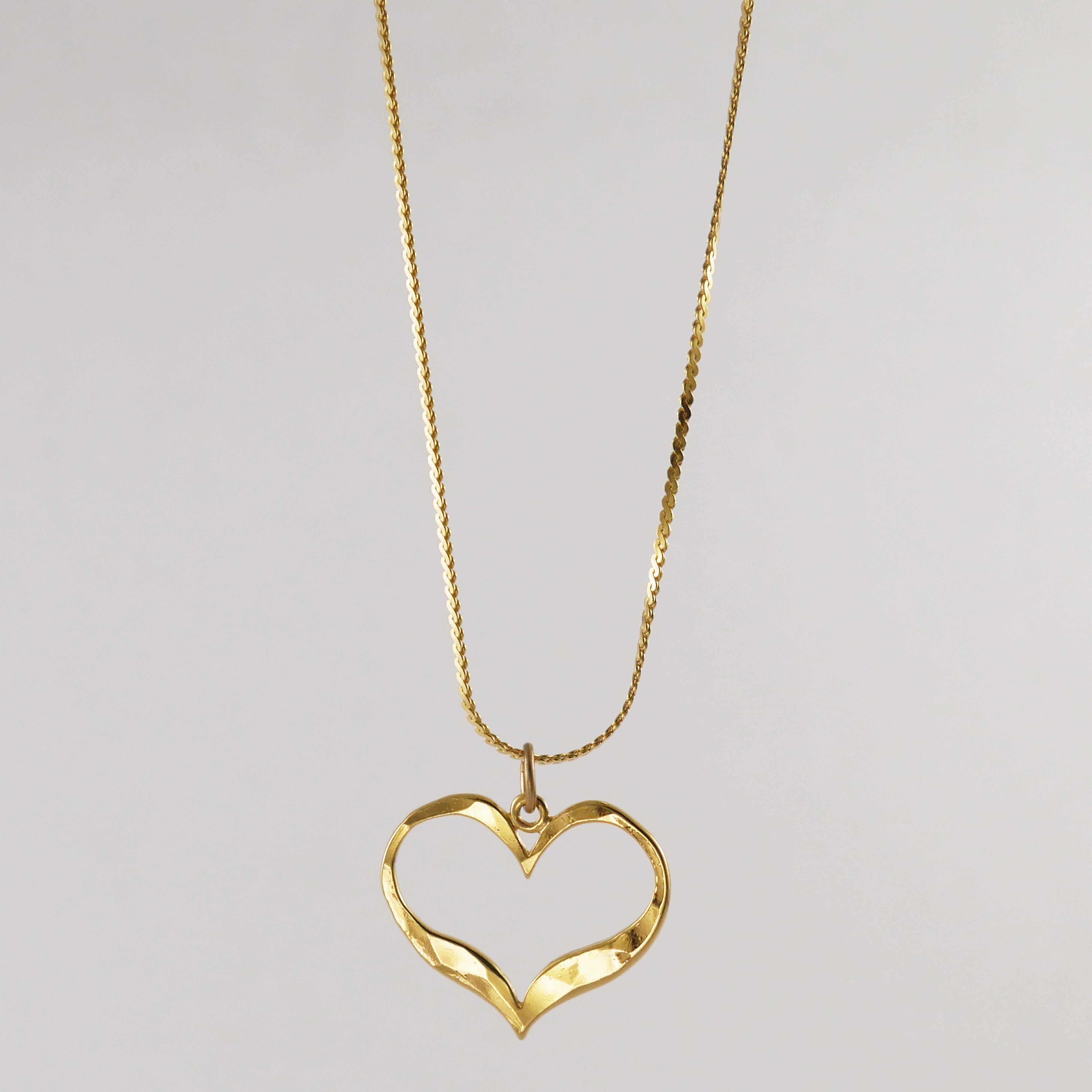 Gold heart-shaped pendant on a chain 